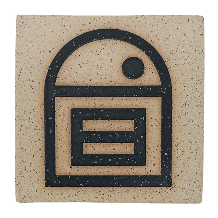 A 4-inch square tile with a matte black 'House of Equality' symbol design on a speckled stoneware background.